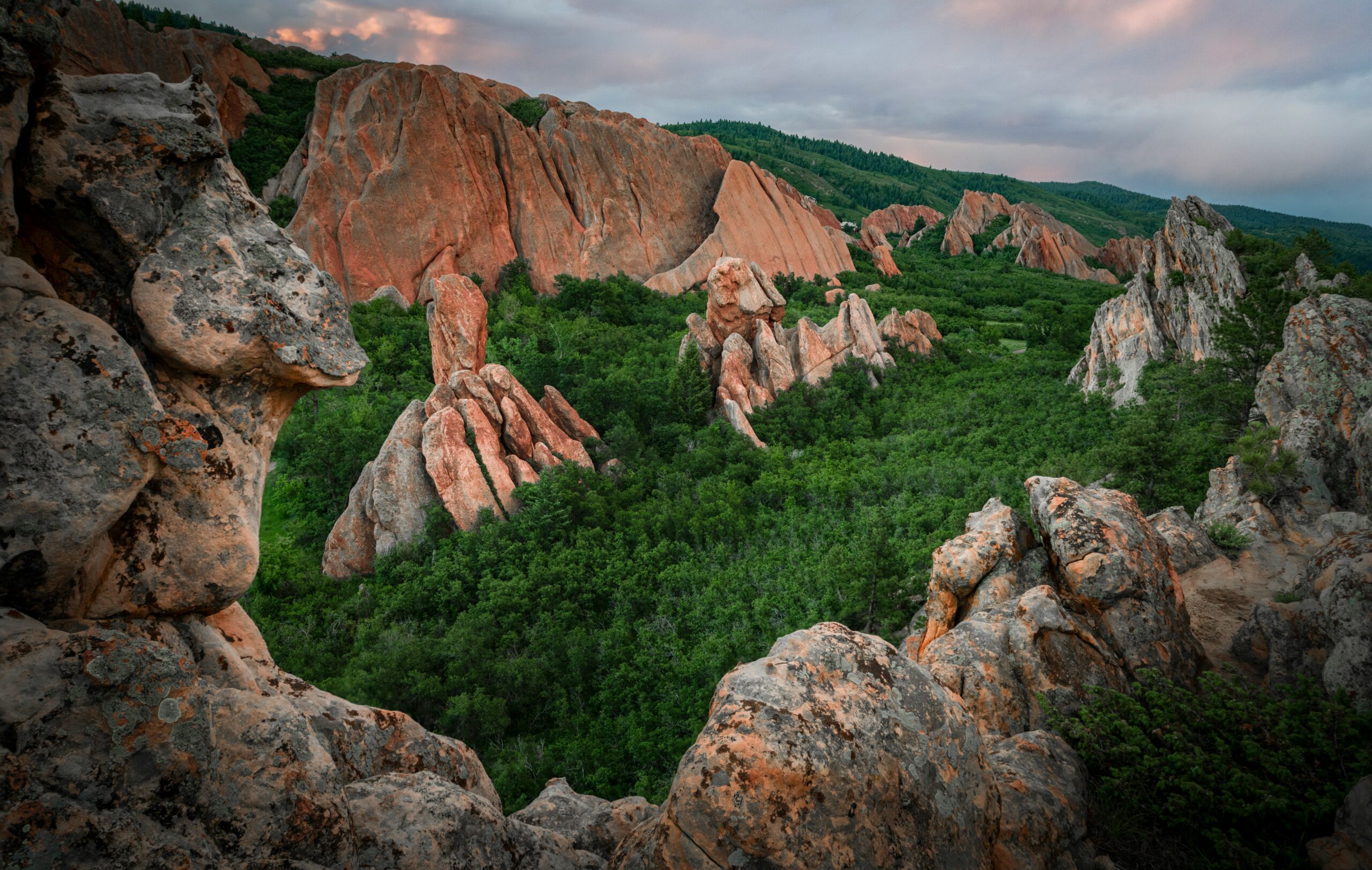 brown rock formation on green grass field during daytime