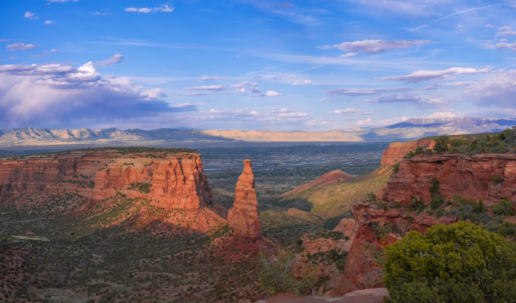 Colorado National Parks, Colorado National Monument, a scenic view of a mountain range with mountains in the background